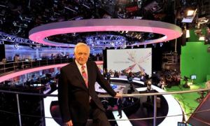 David Dimbleby stands over the BBC's Election Night studio. 